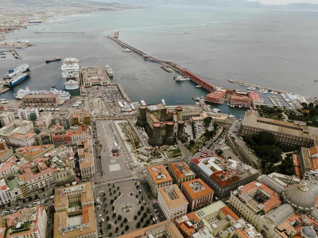 Ferry from Naples to Capri is docking on Molo Beverello pier in front of the Angevine Castle in Naples